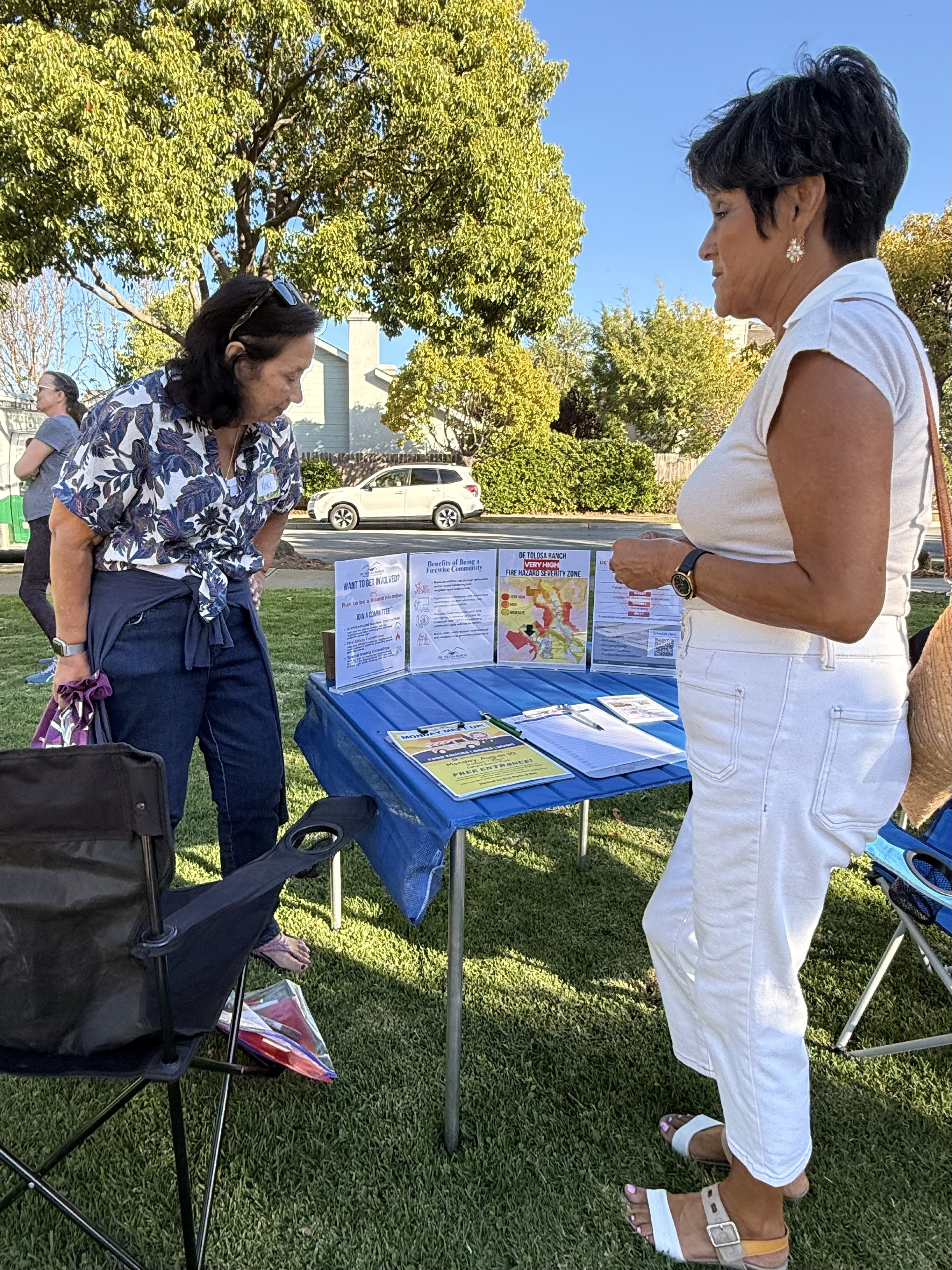 Photo of Supervisor Ortiz-Legg looking at fire information both at National Night Out