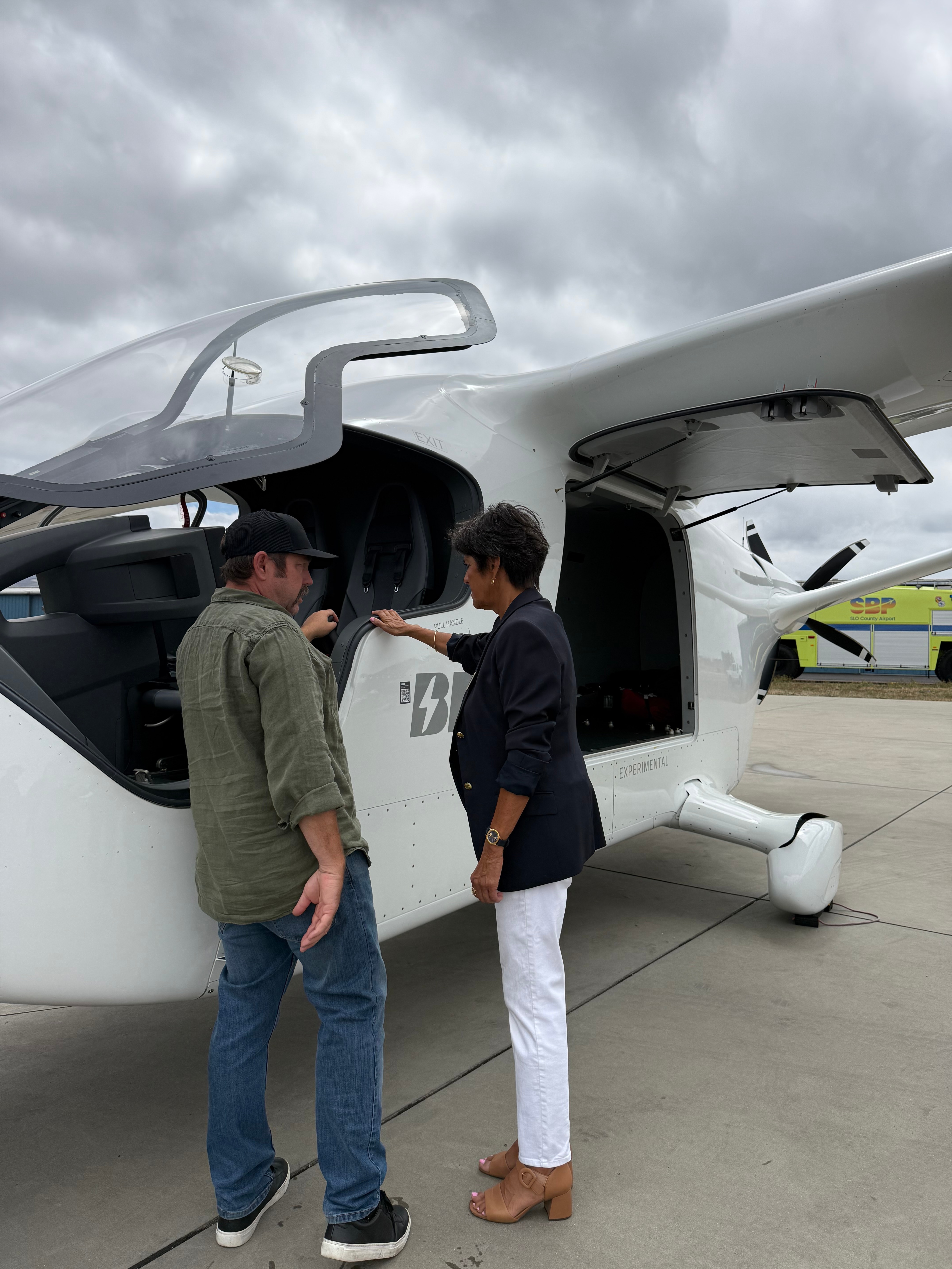 Photo of Supervisor Ortiz-Legg looking at electric aircraft