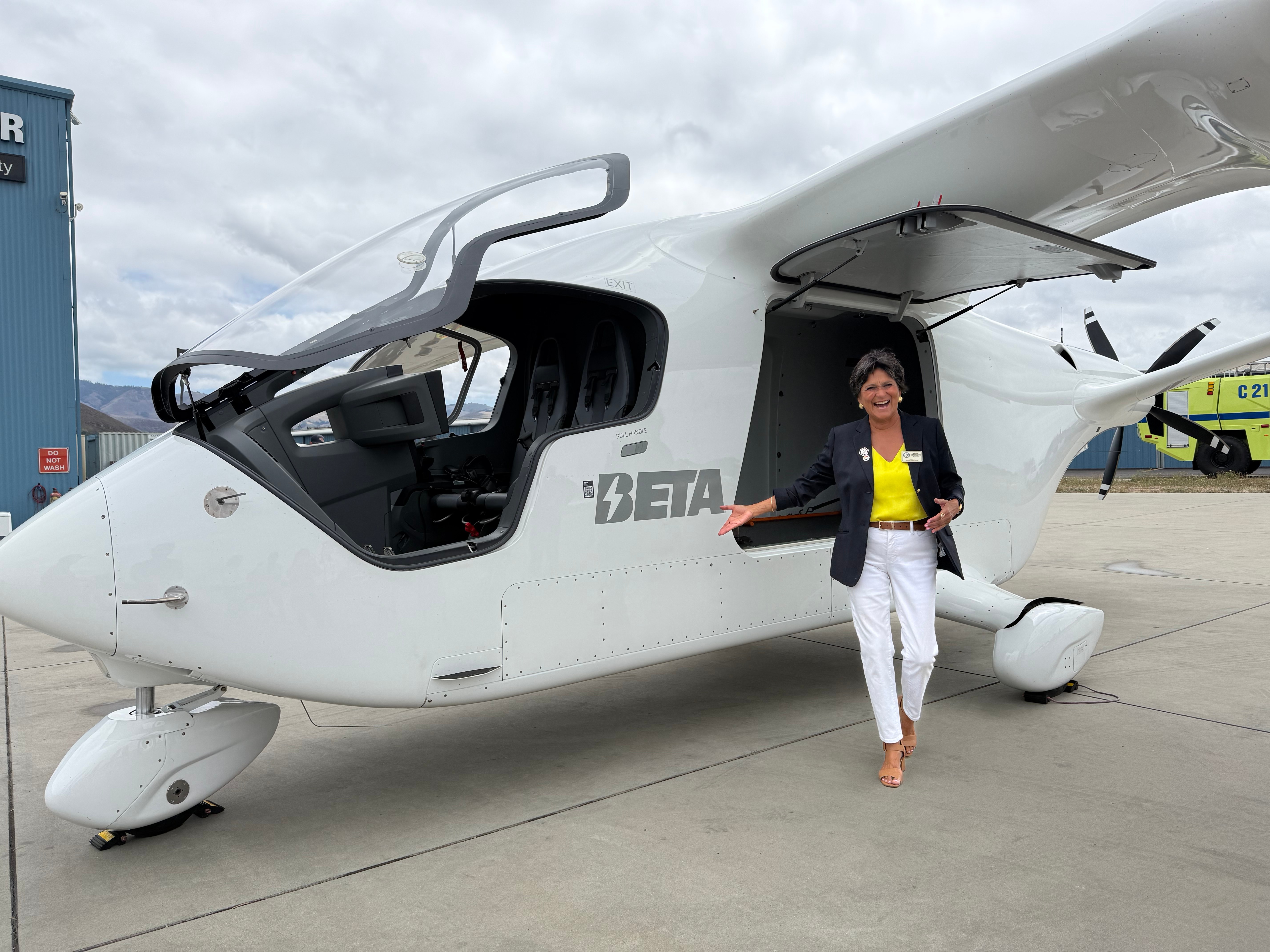 Photo of Supervisor Ortiz-Legg standing next to an electric aircraft