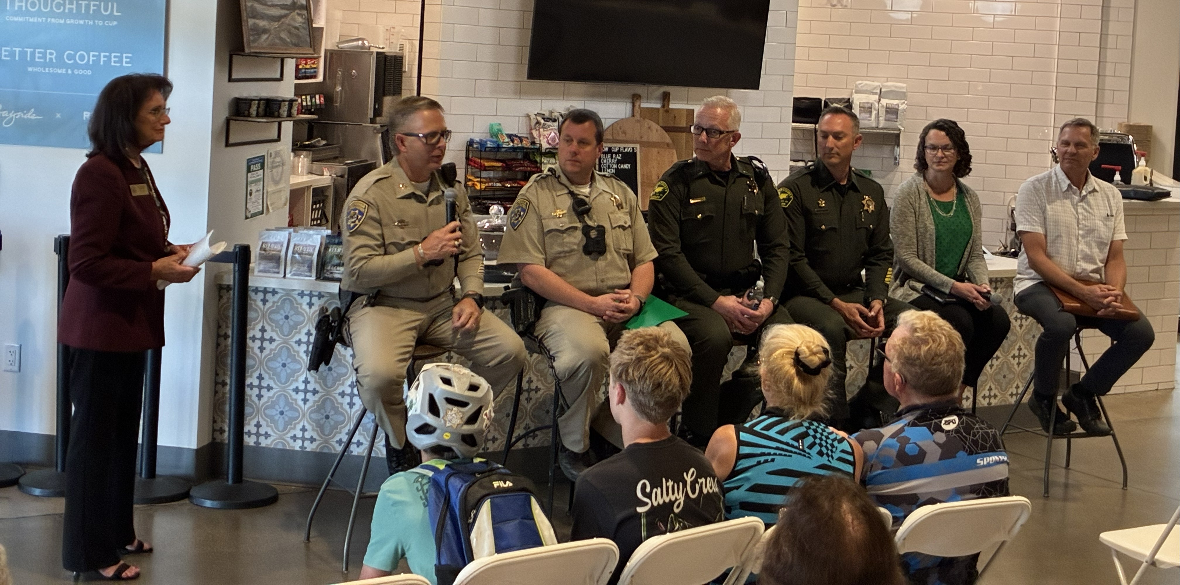 Supervisor Jones moderating a panel with CHP, Placer County Sheriff, Placer County Department of Public Works, and School Resource Officer in front of a cafe counter at the Bayside Granite Bay Cafe.