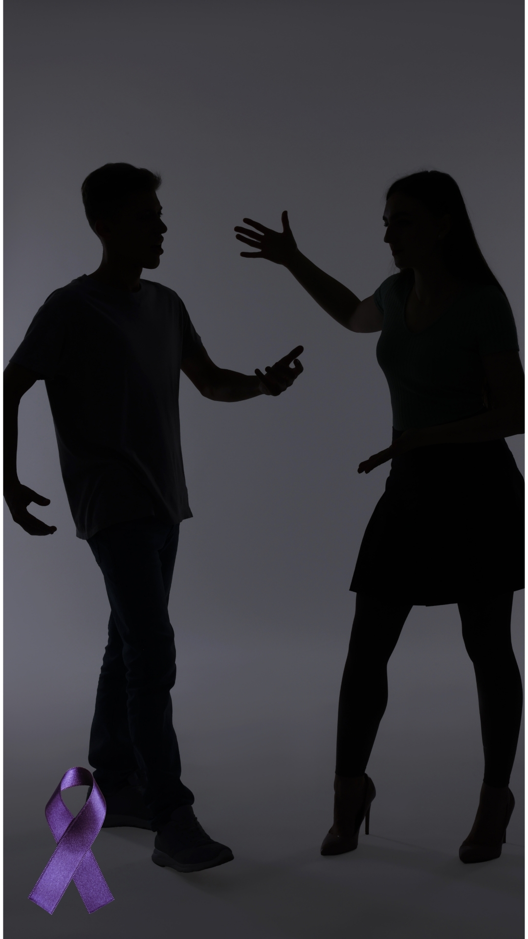 Silhouettes of two individuals facing each other in a studio setting, with one person extending an arm toward the other. A purple awareness ribbon is placed near the lower corner of the image.